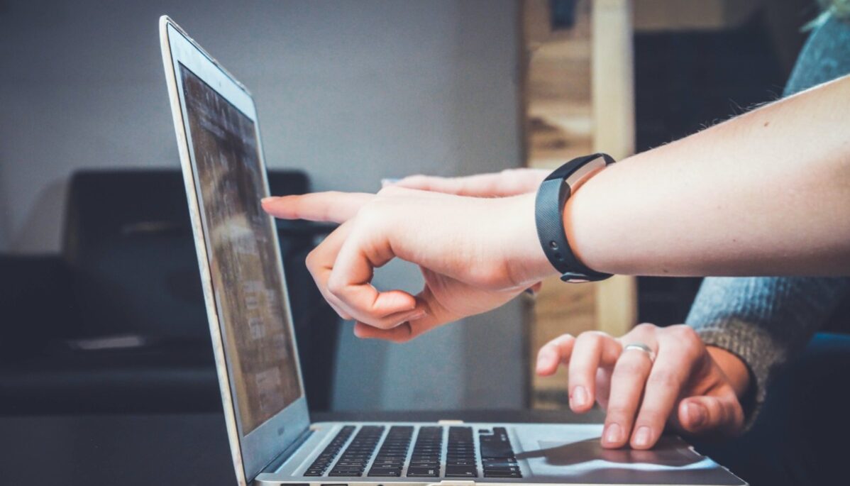 conseils agence de communication Personne qui donne un conseil à une autre en montrant l'écran de l'ordinateur