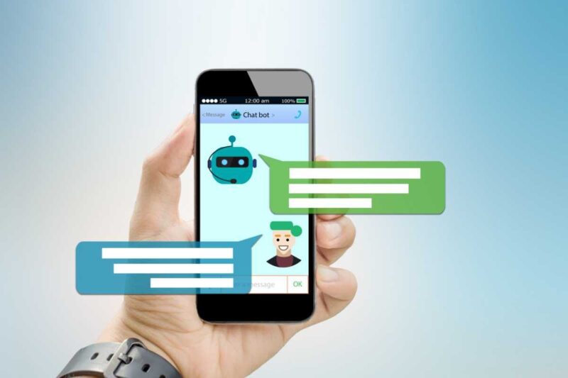 Une main tenant un smartphone affichant une conversation avec un chatbot, avec des icônes de messages flottant à l'écran sur fond bleu clair.
